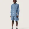 Koszulka unisex Journey z jasnoniebieskiej bawełny typu chambray z frędzlowym wykończeniem i haftowaną naszywką